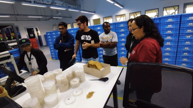 Consie Parducho tours participants inside the seed preparation room at PGF