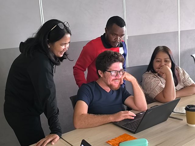 (L-R) Connie Lotho, David Muruu, and May Ann Sallan assist Luis Hernández in creating experiments in EBS